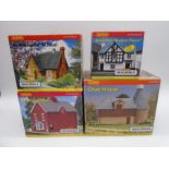A collection of four boxed Hornby Skaledale OO gauge scale model buildings including St Michaels