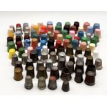 A collection of various thimbles including a number of silver examples