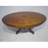 A Victorian inlaid oval tip-up table
