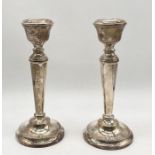 A pair of hallmarked silver candlesticks, height 15.5cm