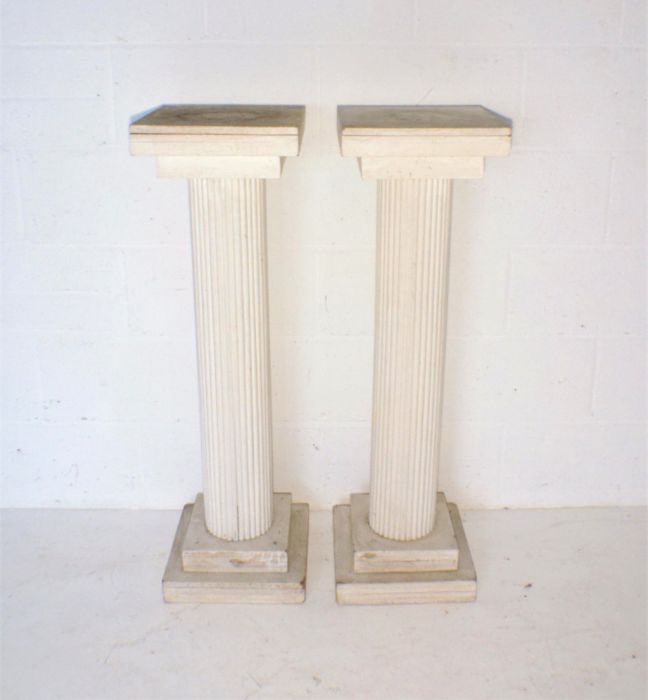 A pair of painted wooden columns, height 102cm.