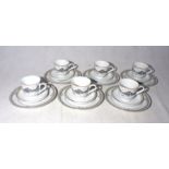 A part tea set including six cups, six saucers and six plates entitled Axminster 2001, depicting