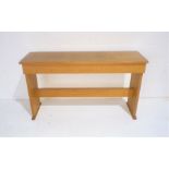 A wooden organ stool with lift up seat, length 116cm, height 66cm.