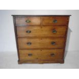 A Victorian pitch pine chest of five drawers with brass handles (one handle A/F)