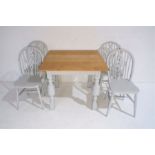 A part painted oak table with a set of four painted wheelback chairs.