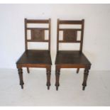 A pair of chapel style chairs.