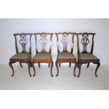 A set of four turn of the century mahogany Hepplewhite dining chairs, on cabriole legs.