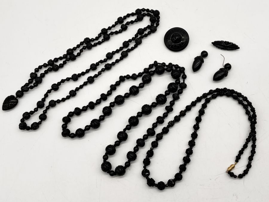 A collection of Whitby jet including acorn earrings (A/F), 2 brooches and 3 necklaces