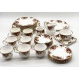 A Royal Albert Country Roses part service including dinner plates, side plates, teacups, saucers,