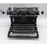 A vintage Imperial 58 typewriter with two spare ribbons.