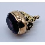 A 9ct gold fob (hallmarked rubbed) set with an amethyst