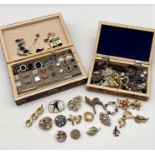 A collection of costume jewellery in two carved wooden boxes including a number of brooches,