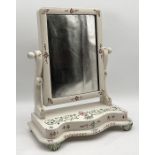 A painted Victorian toilet mirror with floral patterns