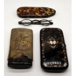 A tortoiseshell cigar case inlaid with gold and silver along with a tortoiseshell pair of glasses in