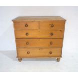 A pine chest of five drawers, raised on turned legs, length 107.5cm, depth 79cm, height 77cm.