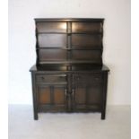 An Ercol dark wood dresser with two drawers and cupboard under, length 123cm, height 161cm.