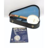 A George Formby banjolele with carry case and 'The Banjo and How To Play It' vintage book by Emile