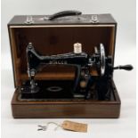 A Singer 99E vintage sewing machine with case, instructions and keys.