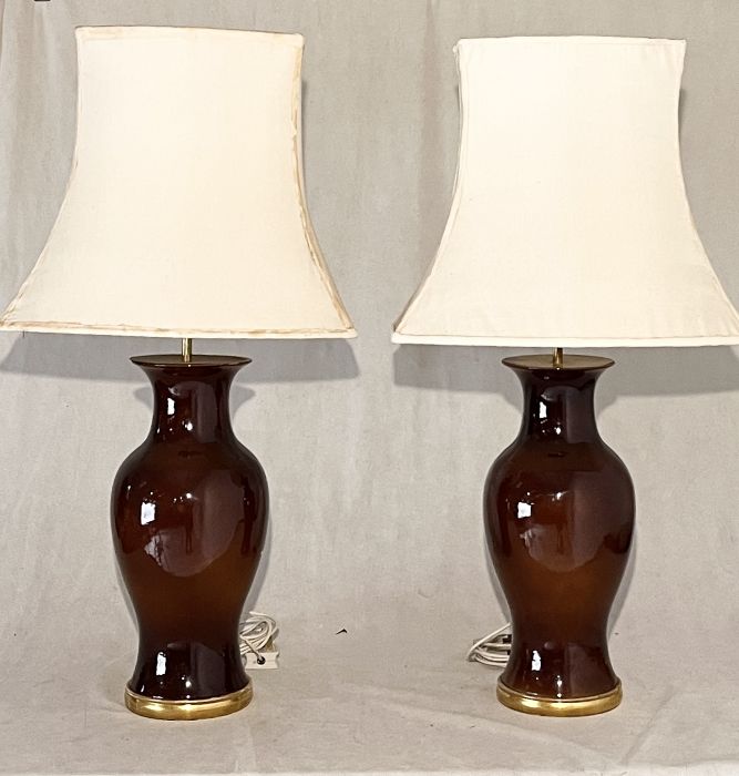 A pair of glazed table lamps with shades