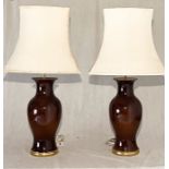 A pair of glazed table lamps with shades