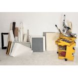 A collection of various art supplies along with a portable artist's storage unit/trolley