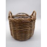 Two wicker baskets, one contains pot pourri the other decorative fir cones