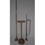 Two copper hunting horns plus a vintage washing dolly.