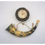 A Black Forest clock along with a hunting horn.