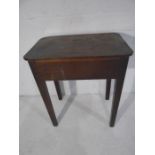 An antique mahogany occasional table