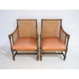 A pair of bergère armchairs with barley twist decoration.