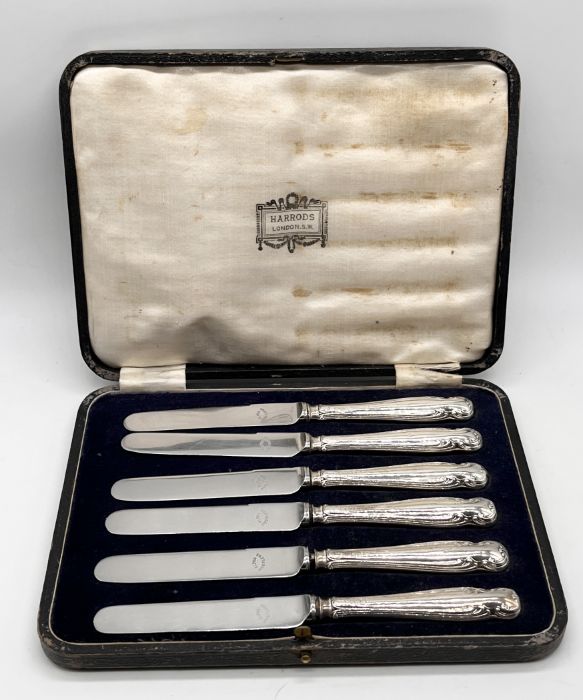 A cased set of silver handled butter knives retailed by Harrods