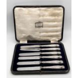 A cased set of silver handled butter knives retailed by Harrods
