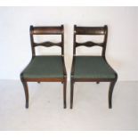 A pair of Regency dining chairs.