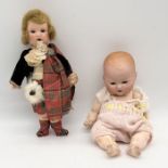 Two antique bisque headed dolls including Armand Marseille baby doll and girl in traditional