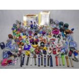 A large collection of McDonald's happy meal toys including Disney, The Muppets, The Mask, Ronald