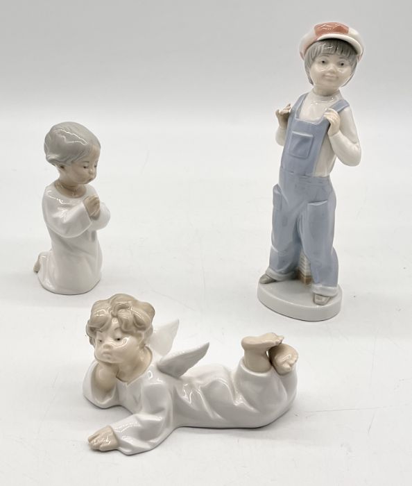 Three Lladro figurines including Boy from Madrid, Angel Lying Down and Praying Angel (A/F)