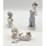 Three Lladro figurines including Boy from Madrid, Angel Lying Down and Praying Angel (A/F)