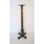 A mahogany torchere with carved detailing, height 144.5cm.