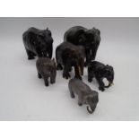 A collection of vintage elephants including ebony and ceramic