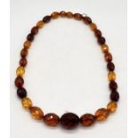 A Baltic amber necklace with faceted beads, weight 36.6g