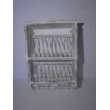 A painted wall hanging plate rack
