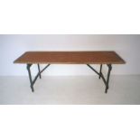 A trestle table with painted legs, length 216cm, width 64cm, height 76cm.