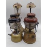 Four vintage oil lamp burners, two pairs, one shade missing.
