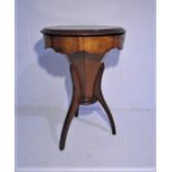 A Victorian octagonal sewing table on a tripod base.