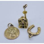 A 14ct gold charm in the form of a Mosque (weight 2.2g) along with a 9ct St Christopher and a