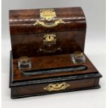 A Victorian walnut stationary/desk box with applied brass mounts enclosing a divided interior over a