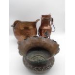 A hammered copper thistle shaped jardiniere along with a coal bucket and water vessel on wrought
