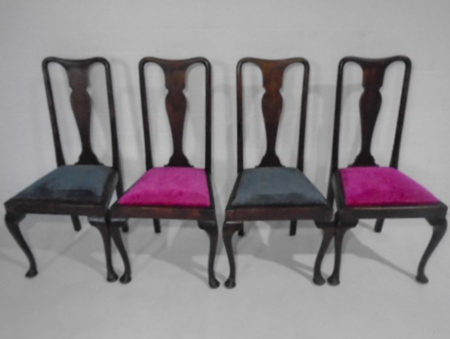 A set of four Queen Anne style dining chairs upholstered in a contemporary fabric.