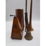 A collection of copper items including a bell, a hunting horn etc plus a metronome.
