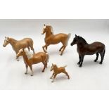 A collection of Beswick horses including four palomino examples and a Dartmoor pony